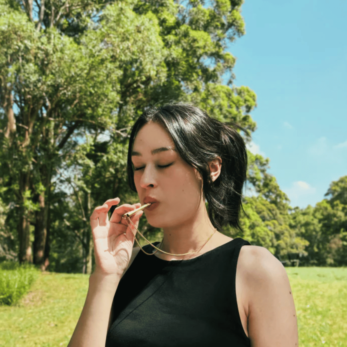 woman using Breathlace breathing necklace
